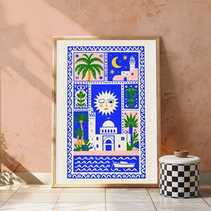 May include: A rectangular wall art print featuring a vibrant blue, pink, and white illustration of a Mediterranean coastal scene. The design includes a winking sun, a mosque, palm trees, a crescent moon, and a small boat on wavy water.