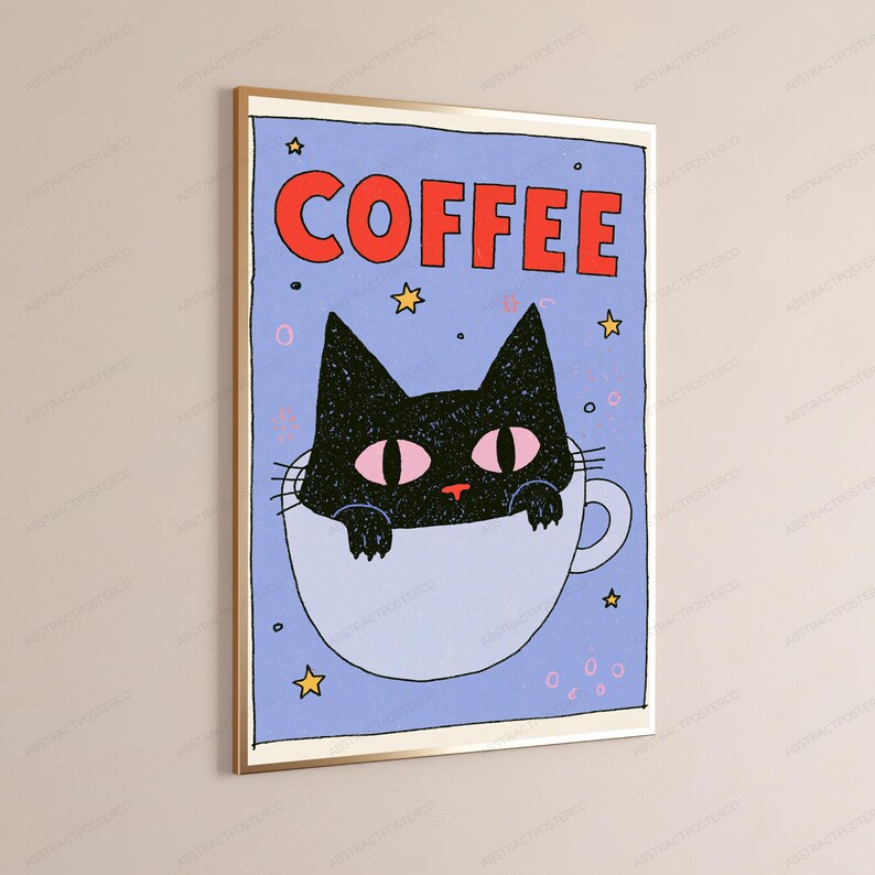 May include: A framed wall art print featuring a light blue background with the word COFFEE in bold red letters at the top. A black cat with pink eyes is illustrated peeking out from a white coffee mug, surrounded by small yellow stars.