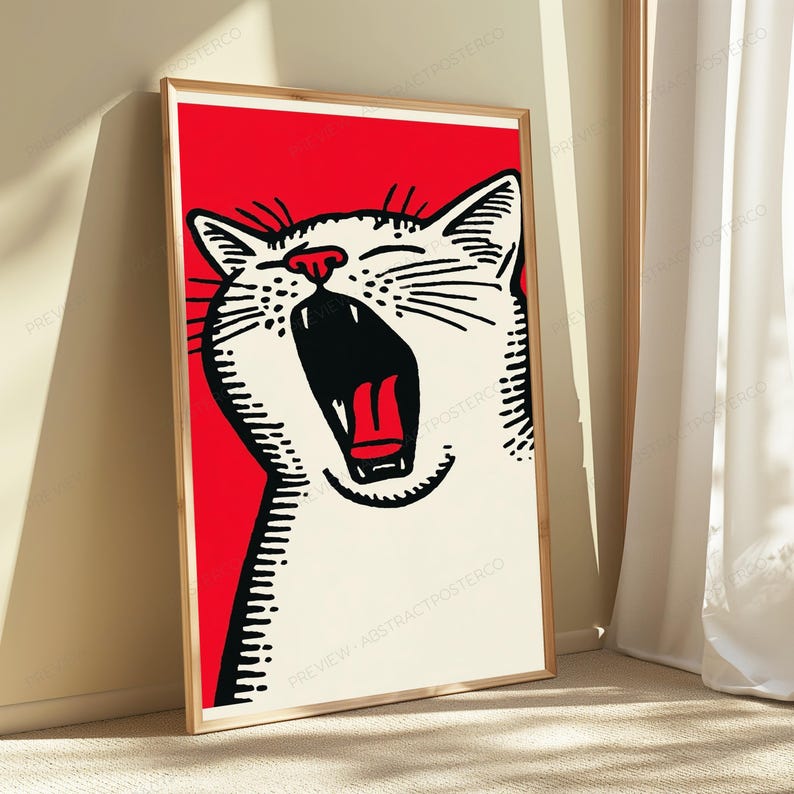 May include: A framed vertical wall art print featuring a stylized black and white illustration of a yawning cat against a solid red background. The cat has a wide-open mouth showing a red tongue, with bold black outlines and a light-colored fur.
