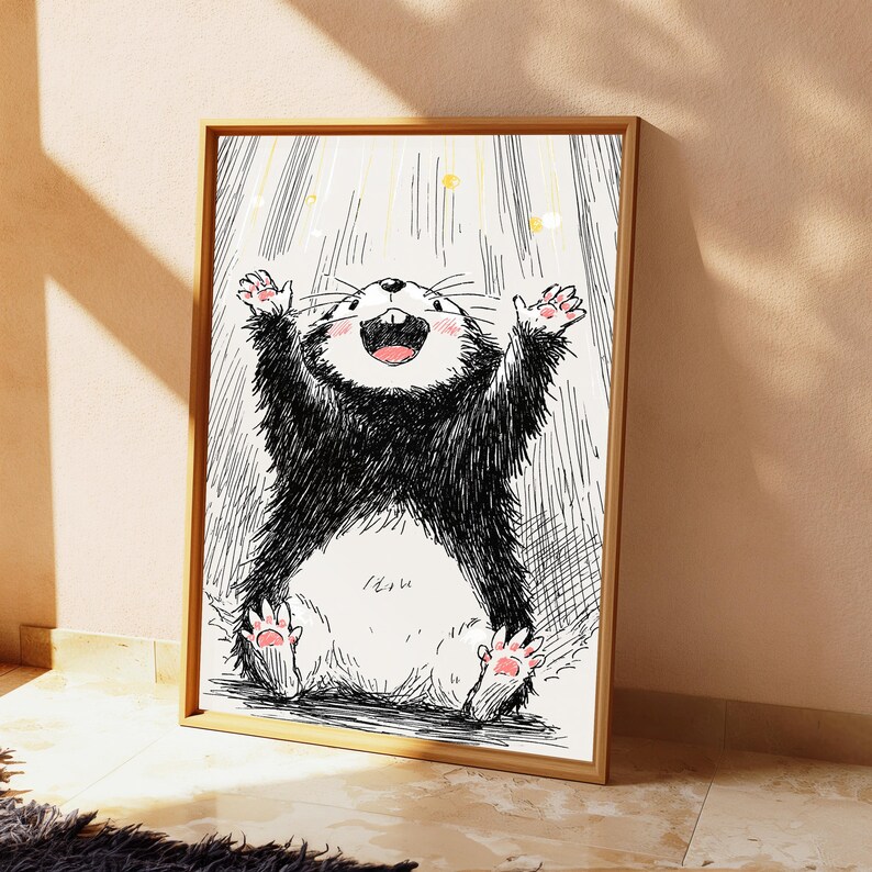 May include: A framed wall art print featuring a black and white ink-style illustration of a cheerful, furry creature with its arms raised upward. The creature has a white belly, pink paw pads, and a wide, happy expression with visible teeth.