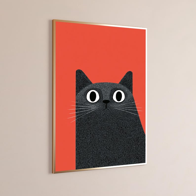 May include: A framed wall art print featuring a stylized illustration of a black cat with large white eyes and long white whiskers. The cat is positioned against a solid, vibrant orange background, and the artwork is encased in a thin gold frame.