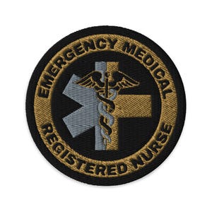 May include: A round, black embroidered patch with gold stitching. The patch features a medical symbol with a snake and wings, a star of life, and the text "Emergency Medical Registered Nurse".