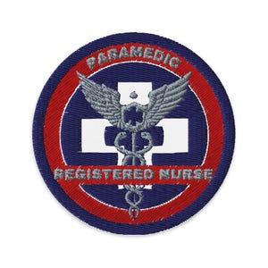 May include: A blue and red embroidered patch with a white cross and a caduceus with wings. The text "PARAMEDIC REGISTERED NURSE" is around the outside of the patch.