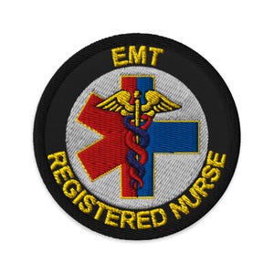 May include: A circular embroidered patch with a black border featuring the yellow text EMT at the top and REGISTERED NURSE at the bottom. The center displays a white Star of Life symbol with a red and blue cross and a gold caduceus emblem.