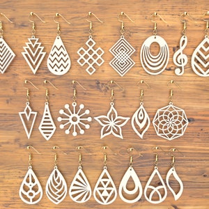 May include: Twenty white wooden earrings with gold hooks. The earrings feature various geometric and abstract designs, including a flower, a music note, a snowflake, and a teardrop.