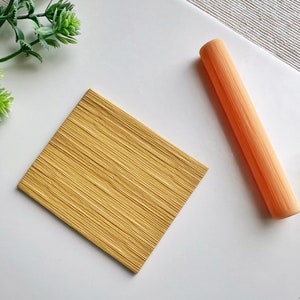 May include: A yellow textured rolling pin and a square piece of textured yellow fondant.