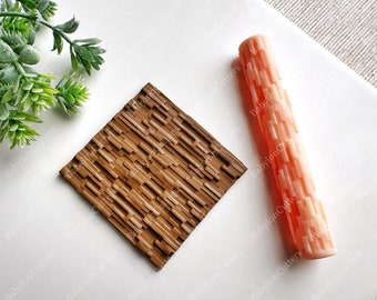 May include: Two silicone baking tools for creating textured designs on cakes and pastries. A brown square textured sheet and a pink rolling pin with a brick pattern.