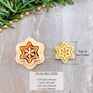 May include: Two snowflake cookie cutters, one larger and one smaller, on a light brown surface. The larger cutter is 1.5 inches (38 mm) in diameter and the smaller cutter is 0.75 inches (19 mm) in diameter.  AVAILABLE SIZES: 0.75 inch (19mm), 1 inch (25 mm), 1.25 inch (32mm), 1.5 inch (38mm).