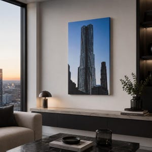 May include: A canvas print of a tall, modern skyscraper against a blue sky. The building has a unique, textured facade and is set in an urban environment. The artwork is displayed in a contemporary living space.