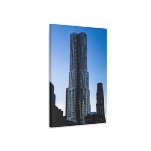 May include: A tall, modern skyscraper with a unique, curved design stands out against a blue sky. The building is made of glass and metal, and it has a sleek, contemporary look.