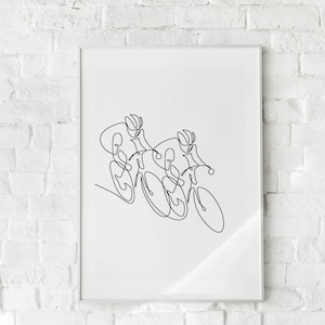 May include: A black and white line drawing of two cyclists racing on bicycles. The drawing is framed and hanging on a white brick wall.
