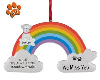 May include: White dog rainbow ornament with the words "Until We Meet At The Rainbow Bridge" and "We Miss You". The dog's name is "Barker".