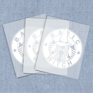 May include: Three white vinyl stickers with the text "Basic Witch" in a circle with a witch silhouette in the center.