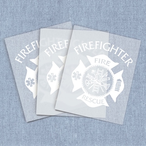 May include: Three white vinyl decals with the words "Firefighter" and "Fire Rescue" and a firefighter's helmet, axe, ladder, and hose.