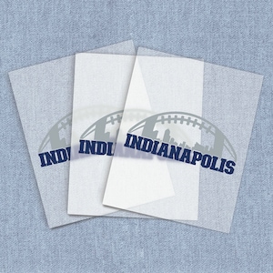 May include: Three sheets of clear vinyl with a gray silhouette of a football with a cityscape inside and the text "INDIANAPOLIS" in blue.