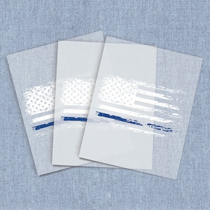 May include: Three white cards with a blue line and a faded American flag design. The cards are stacked on top of each other.
