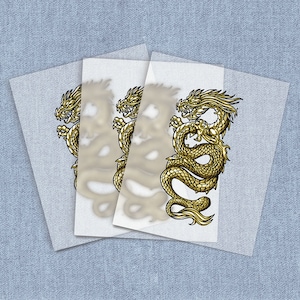 May include: Three sheets of clear transfer paper with a gold dragon design printed on each sheet. The dragon is curled up with its head facing the right side of the image.
