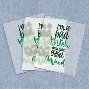 May include: Three sheets of clear vinyl with the text "I'm a bad bitch with some good weed" printed in black and green. The text is in a cursive font.
