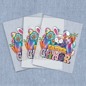 May include: Three colorful iron-on transfers featuring a bunny holding a video game controller with Easter eggs and the text "Easter Gamer".