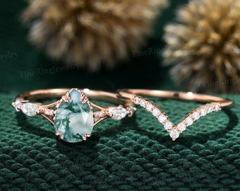 May include: A pear-shaped green moss agate engagement ring set in rose gold with a matching rose gold band featuring a V-shaped row of small diamonds.