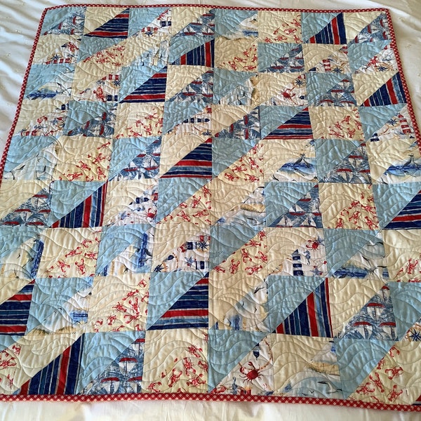 A very attractive handmade quilt suitable for a child’s bed.  100% cotton. Machine washable.  Sailing boats & seaside fabric.