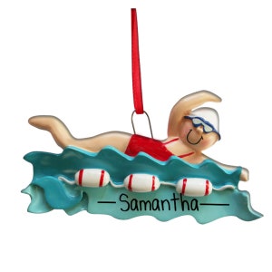 May include: A personalized Christmas ornament featuring a swimmer in a red swimsuit, swimming in blue water with three red and white life preservers. The ornament has the name "Samantha" written on it.