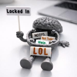 May include: A gray brain-shaped figurine with arms and legs, holding a white sign that reads Locked In. The open brain cavity contains small white rectangular tiles with the text NOTED, Not Today, and Welp, while a LOL sign rests on its lap.