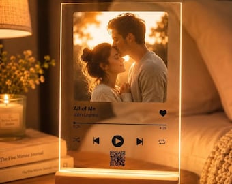 May include: A rectangular acrylic plaque with a warm LED light base displaying a photograph of a couple embracing at sunset. The design includes the song title All of Me, artist John Legend, a playback progress bar, media icons, and a QR code.