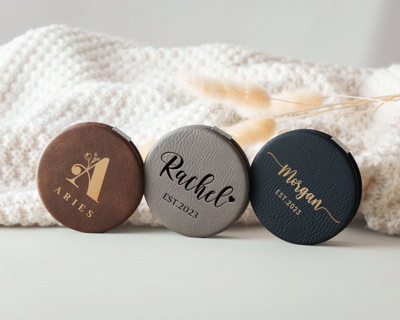 three personalized coasters sitting on top of a white blanket