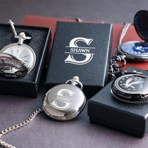 a collection of pendants and boxes with the name "Shawn" engraved on them.