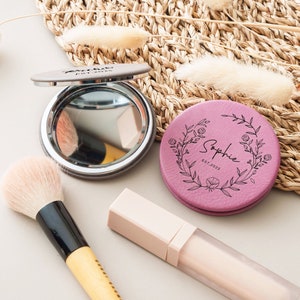 a compact mirror, compact brush, compact powder, and a compact mirror on a