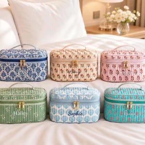 May include: Six rectangular quilted cosmetic bags with top handles and gold-tone double zippers. The bags feature various floral and shell patterns in blue, beige, pink, green, and teal, with personalized names embroidered on the front of each bag.