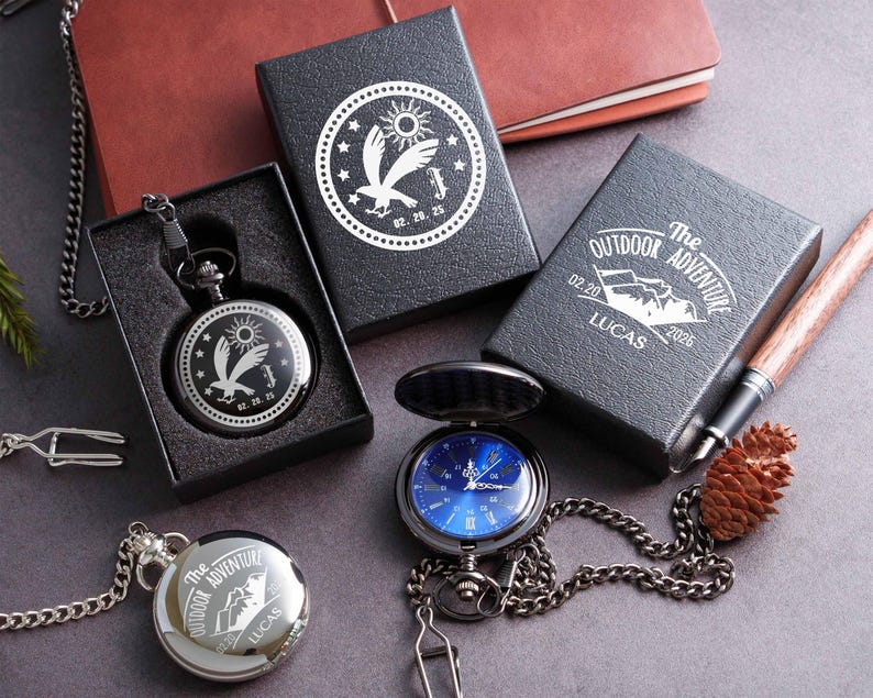 a collection of outdoor adventure-themed items, including a pocket watch, a notebook, a pen, and a pine cone.