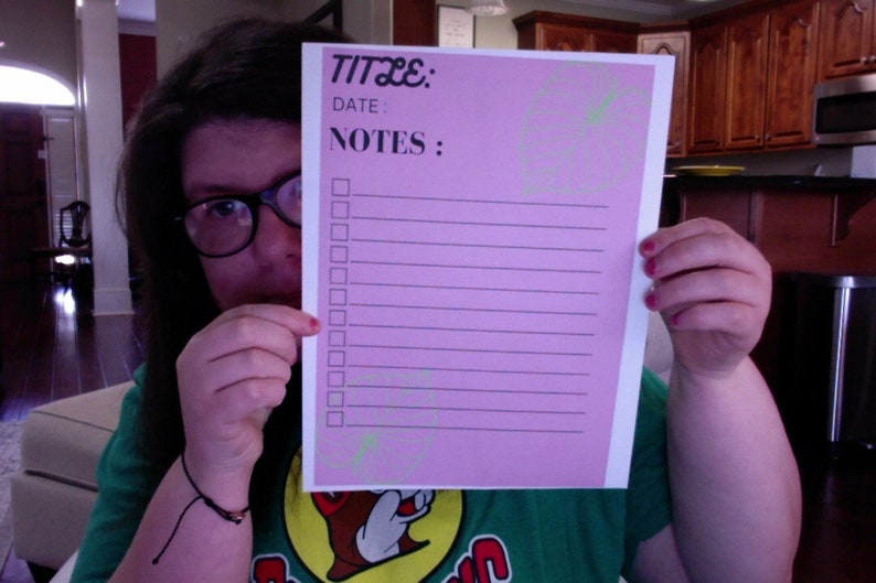May include: A pink checklist with the words "TITLE:" and "NOTES:" at the top. There are 15 blank lines with checkboxes next to each line.
