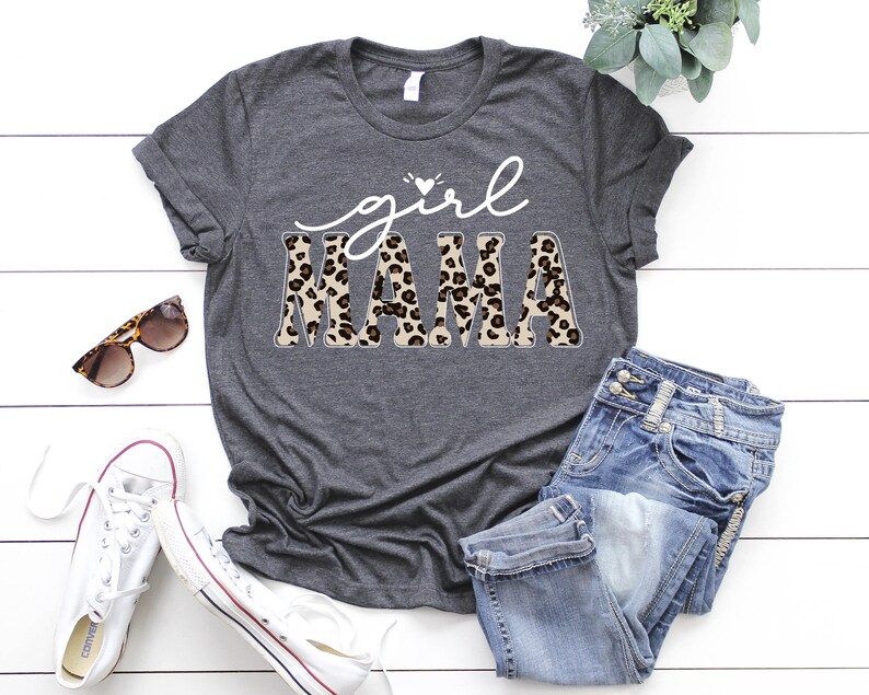 May include: A gray t-shirt with the text "girl mama" in white with a leopard print design.
