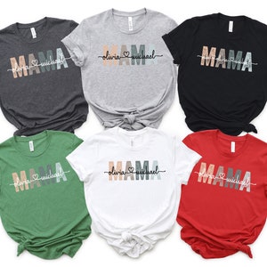 May include: Six t-shirts in different colours with the word "MAMA" in colourful letters and the text "olivia &hearts; michael" underneath. The shirts are in grey, light grey, black, green, white and red.