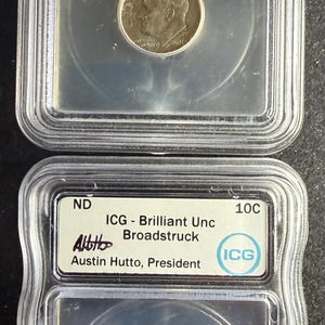 May include: Two silver-coloured Roosevelt dimes encapsulated in clear plastic ICG grading slabs. Each label reads ND, 10C, ICG - Brilliant Unc Broadstruck, and Austin Hutto, President. The coins feature a profile portrait of Franklin D. Roosevelt.
