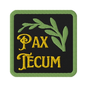 May include: A green and black embroidered patch with the words "Pax Tecum" in gold lettering and a green olive branch design.