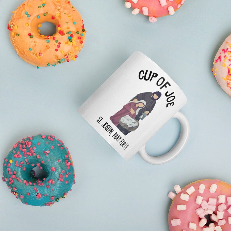 This traditional Catholic coffee mug honors St. Joseph. It reads whimsically, "Cup of Joe."