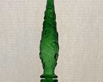May include: A tall, green glass bottle with a textured, swirling pattern. The bottle has a conical shape and a matching stopper. The bottle is approximately 12 inches tall.