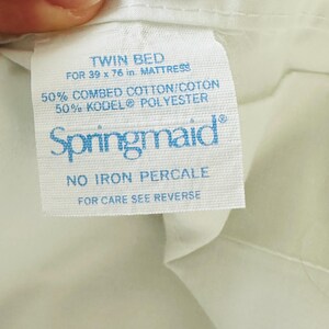 May include: A white fabric tag with blue text reads "TWIN BED FOR 39 x 76 in. MATTRESS." The tag also states the fabric is 50% combed cotton and 50% KODEL&reg; polyester. The brand name "Springmaid" is visible.