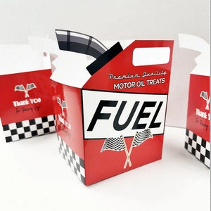 May include: Red and black favor boxes with a checkered pattern and a racing theme. The boxes have a cut-out handle and say "Premium Quality Motor Oil Treats Fuel" with a checkered flag design.