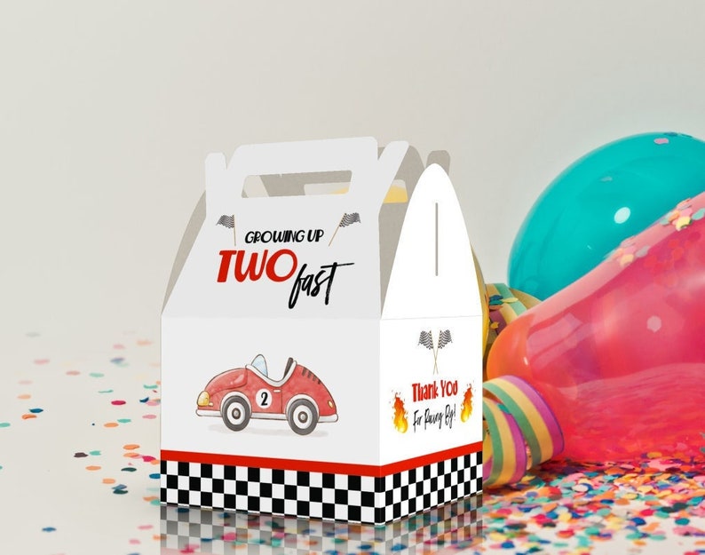 May include: White favor box with a red race car and the text "Growing Up Two Fast". The box has a checkered flag design and the text "Thank You for coming!"