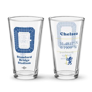 May include: Two clear pint glasses with blue graphics. One glass features a stadium design and the text "Stamford Bridge Stadium". The other glass has the word "Chelsea", coordinates, and a blue lion emblem.
