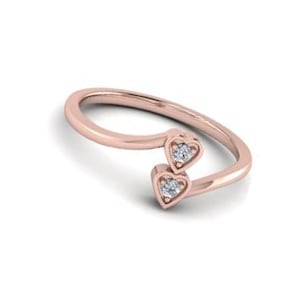 May include: A rose gold ring with two small diamonds set in heart-shaped settings.