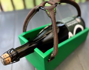 Wooden beer, sour beer, lambic cradle with leather handle. Using features of wood and leather to create this one of a kind bottle holder.