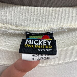 May include: White sweatshirt with a black tag that reads "Mickey Unlimited &copy;Disney" and "Made in USA XLarge".