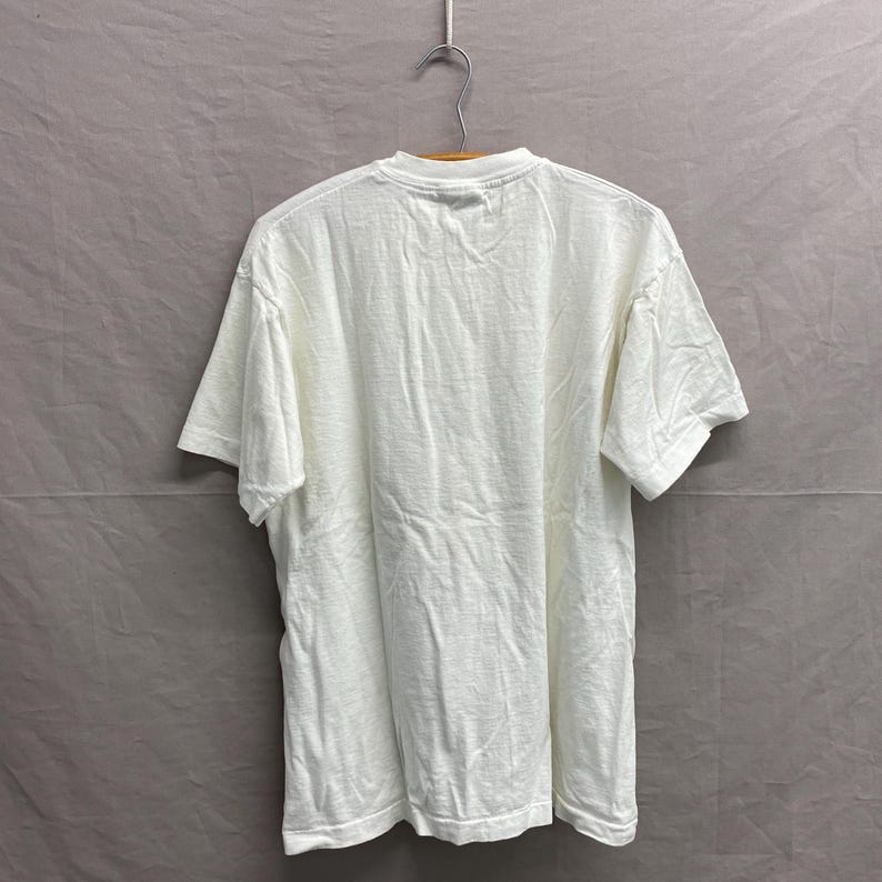 May include: A white t-shirt with a crew neck and short sleeves.