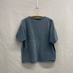 May include: A blue short-sleeved t-shirt hanging on a wooden hanger against a white background.