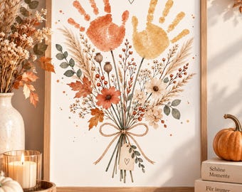 May include: A framed wall art print featuring a watercolor illustration of a bouquet of dried flowers and grasses. Two handprints, one in orange and one in yellow, are positioned at the top. A small tag with a heart drawing hangs from the tied stems.
